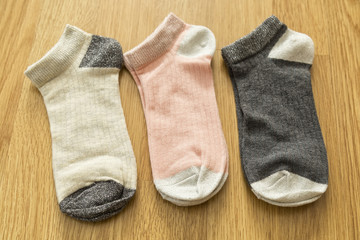 colorful socks on the wooden background.