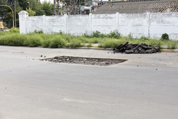 bad asphalt road, repair of asphalt road,  pit on the road