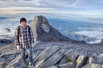 young woman hiking on the top of mount Kinabalu