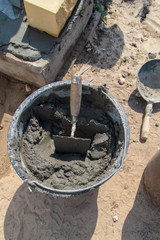 The worker mixes the concrete mixture at the construction site