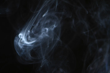 amazing flowing contrast bright smoke on the dark background.