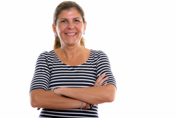 Studio shot of mature happy woman smiling with arms crossed