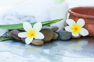 Spa Flowers with dark stones and white towel