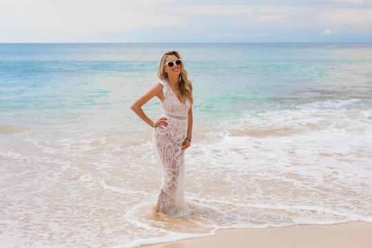 Woman in dress standing in ocean