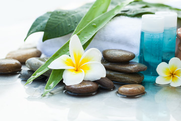 Fototapeta na wymiar Oil tube for body. Body care and spa concept with flower and stones