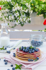 Vintage pancakes outside garden with blueberries