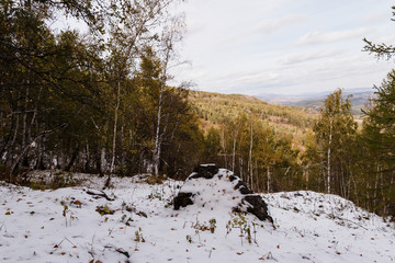 autumn landscape in the mountains with the first snow