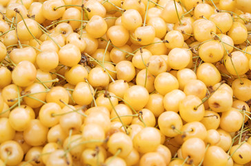 Lot of ripe yellow cherries in the supermarket.