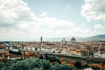 Panorama of Florence Firenze: Duomo, Arno River, towers, cathedrals, tiled roofs of houses from Piazzale Michelangelo, top view, Florence, Tuscany, Italy. Picture is tinted with vintage filter.