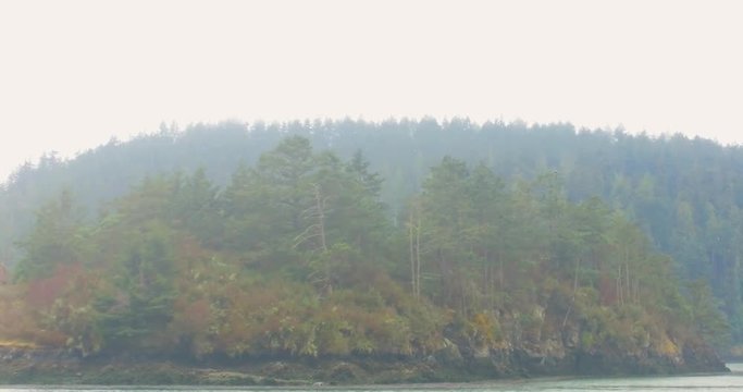 La Conner, WA tourist boat entering Puget Sound on a foggy summer morning