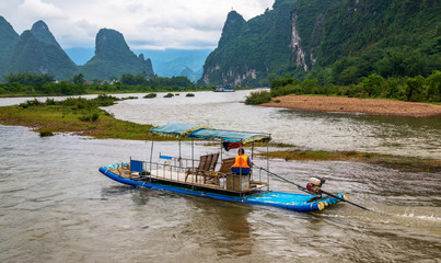 The man on a raft crosses the Li River