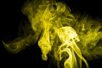 Yellow smoke on black background