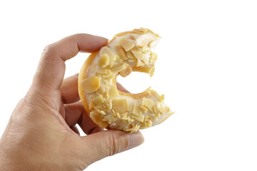 The hand is caught a doughnut isolated on a white background.