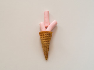 Marshmallow in ice cream cone on white