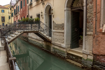 Fototapeta na wymiar View of canal in Venice whis small bridge. Architecture and landmarks of Venice. Italy.