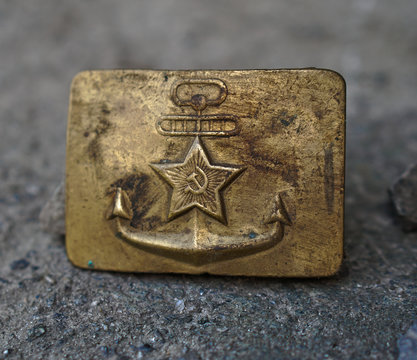 Buckle with the coat of arms of the Soviet Union navy fleet. Golden coat of arms of the USSR against the background of a grunge texture.