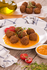 Meatballs with mashed carrots.