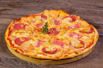 Pizza with ham and sausages
