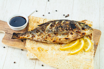 Grilled dorada with lemon