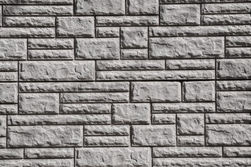Grey wall texture with rectangular of different sizes and shapes, big, small, wide and narrow ones. Various concrete bricks embossed texture