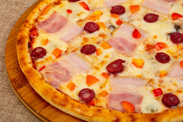 Pizza with ham and sausages