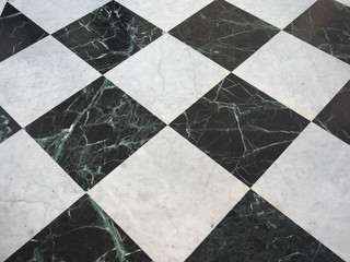 chequered white green and black stone floor background
