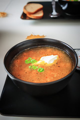 Pumpkin and carrot soup with cream and parsley