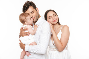 Portrait of a smiling young family with their little baby girl