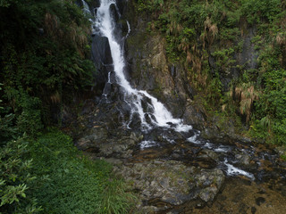 Fototapeta na wymiar Aerial View of Waterfall in the Tropical Rainforest Mountains