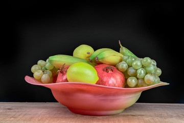 pomegranates and other fruits in a bowl