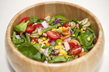 Pasta salad in wooden bowl