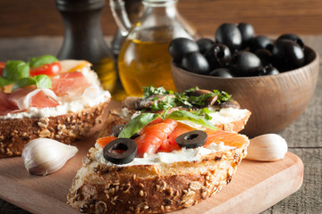 Italian tomato and cheese bruschetta. Tapas, antipasti with chopped vegetables, herbs and oil on...