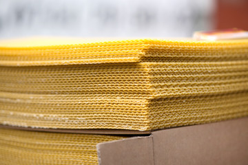 Stack of bee wax sheets. New bee produce wax for creating natural wax candles. Health benefits of using bee wax products.