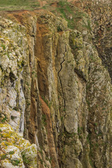 Huge crack on the face of a limestone cliff at Skrinkle Haven on the Pembrokeshire Coast in South Wales