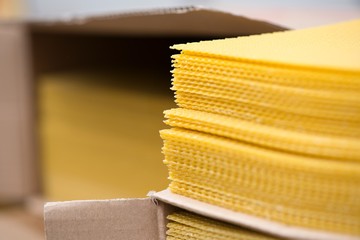 Stack of bee wax sheets. New bee produce wax for creating natural wax candles. Health benefits of...