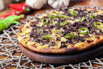 Spicy pizza with minced meat and jalopeno