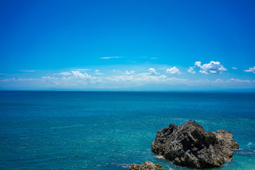 big stone rock blue ocean and sky