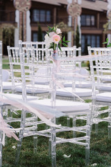 White chairs for guests at a luxury wedding ceremony