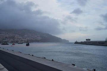 View of Funchal, Madeira from the Marina with a medieval boat on the sea
