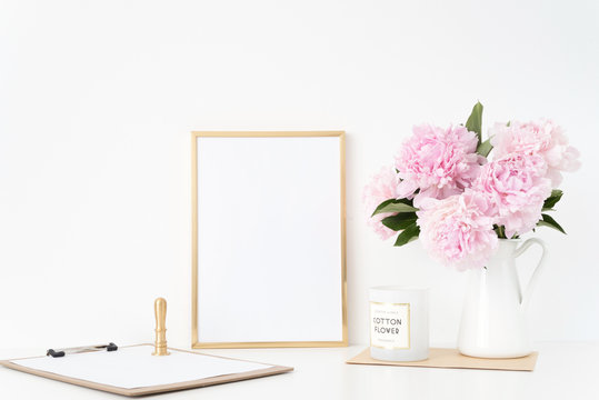 Modern gold portrait a4 frame mock up with a bouquet pink peonies in white jug, gold stamp. Overlay your quote, promotion, headline, or design, great for small businesses, lifestyle bloggers