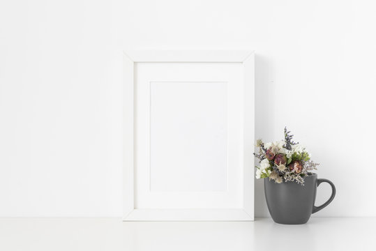 White A5 portrait frame mockup with cute bouquet of dried flowers pot on white wall background. Empty frame, poster mock up for presentation design. Template frame for text, lettering, modern art.