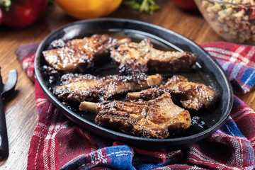 Roasted lamb chops on a roasting dish