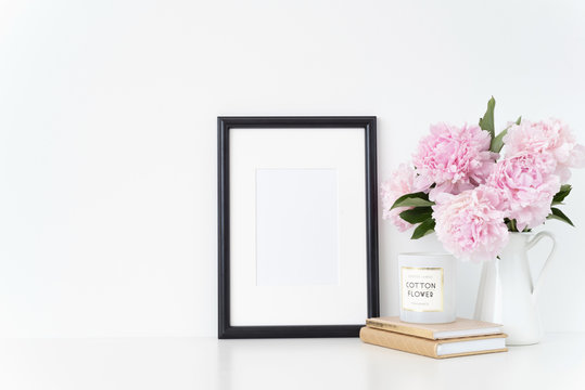 White portrait frame mock up with a pink peonies beside the frame, overlay your quote, promotion, headline, or design, great for small businesses, lifestyle bloggers and social media campaigns. poster