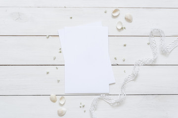 Cute white flat lay with card blank space for you to insert your text, invitation, wedding or logo. Sea mood.Best for social media, backgrounds, headers, blogs, wedding