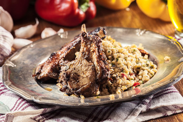 Roasted lamb chops served with bulgur wheat