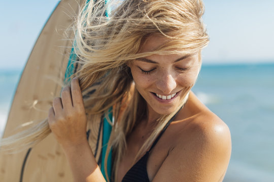 Woman Holding Surf Board