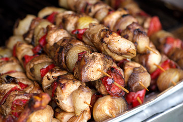Close up of traditionally grilled pork and beef meat on a wooden stick. Eastern European traditional shish kebab with grilled vegetables.