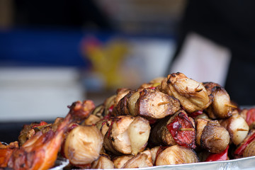 Close up of traditionally grilled pork and beef meat on a wooden stick. Eastern European traditional shish kebab with grilled vegetables.