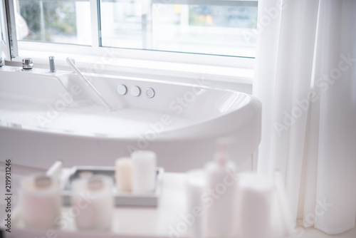 Close Up White Beautiful Bath With Clean Water Locating In Bright Close Up White Beautiful Bath With Clean Water Locating In Bright Cozy Apartment For Treatment And