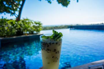 fresh cocktail drink by the pool, holiday mood